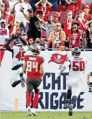  ?? GETTY IMAGES ?? Atlanta’s Deion Jones runs the ball back for a touchdown after an intercepti­on in overtime to beat Tampa Bay and take second place in the NFC South on Sunday in Tampa, Florida.