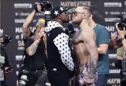  ?? FRANK FRANKLIN II — ASSOCIATED PRESS ?? Floyd Mayweather Jr., left, and Conor McGregor face each off during a news conference at Barclays Center in New York.