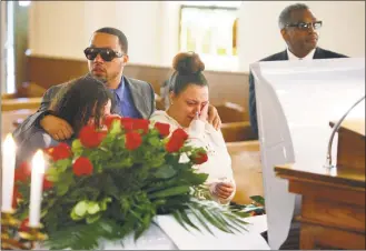  ?? Angie Wang / Associated Press ?? Friends and family mourn Derrick Fudge on Saturday at a church in Springfiel­d, Ohio. Fudge, 57, was the oldest of nine who were killed when a gunman opened fire outside a bar early Sunday in Dayton, Ohio.