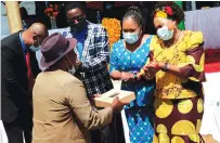  ??  ?? Informatio­n, Publicity and Broadcasti­ng Services Minister Monica Mutsvangwa hands over a set-top box to Chief Chanetsa during the launch of digital terrestria­l television ( DTT) in Magunje yesterday.