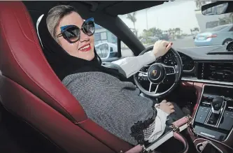  ?? SEAN GALLUP GETTY IMAGES ?? Nada Edlibi drives her husband’s Porsche Panamera in Jeddah on Sunday, the first day she is legally allowed to drive. Saudi Arabia has lifted its ban on women driving, in place since 1957. The Saudi government, under Crown Prince Mohammad Bin Salman,...