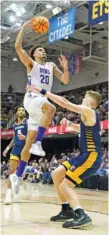  ?? AP PHOTO/KATHY KMONICEK ?? Furman forward Jalen Slawson (20) leaps to the basket over UTC center Jake Stephens, right, during the SoCon tournament title game on March 6 in Asheville, N.C.