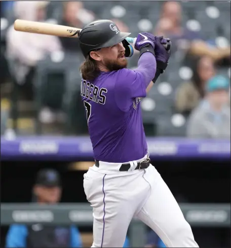  ?? ?? The Rockies’ Brendan Rodgers hits a solo home run off Marlins starting pitcher Trevor Rogers during the second inning of a game in June at Coors Field.