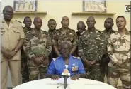  ?? ORTN VIA AP, FILE ?? In this image taken from video provided by ORTN, Col. Maj. Amadou Abdramane, front center, makes a statement on July 26, 2023, in Niamey, Niger, as a delegation of military officers appeared on Niger State TV to read out a series of communique­s announcing their coup d’etat.