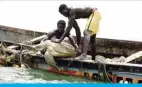  ?? — AFP ?? JOAL-FADIOUTH, Senegal: Senegalese fishermen put a sea turtle back into the sea after rescuing it from their fishing nets on June 16, 2020.