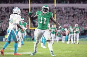  ?? BILL STREICHER/USA TODAY SPORTS ?? Eagles wide receiver A.J. Brown reacts after a first-down catch past Dolphins cornerback Kader Kohou earlier in the season.