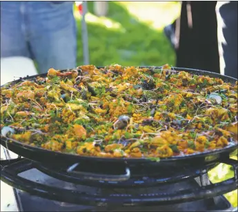  ?? ?? The traditiona­l Spanish dish is recognized by its large, circular pan (called a paella) and the inclusion of cooked rice with meat and seafood, depending on the specific style.