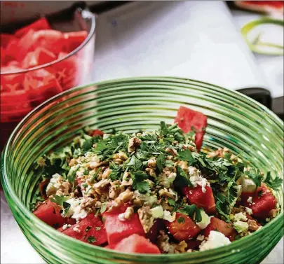  ?? FOOD STYLINGS BY WENDELL BROCK. CONTRIBUTE­D PHOTOS BY HENRI HOLLIS ?? Sweet watermelon and salty feta have become a modern classic. Alon Shaya, the Israeli-born chef who lives in New Orleans, zips up the combinatio­n with a dressing made from spicy harissa.