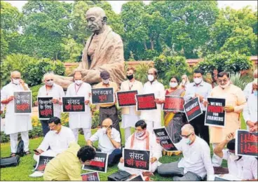  ?? ANI ?? Lawmakers of opposition parties, including the suspended MPs, hold protest against the suspension of eight MPs in the Parliament premises in New Delhi on Monday.