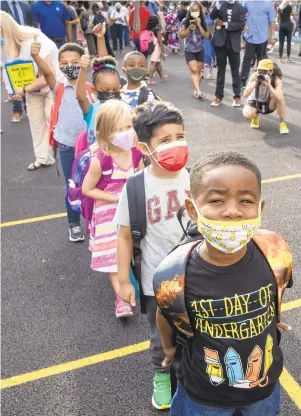  ?? TRIBUNE NEWS SERVICE ?? Kindergart­ners wait to start their first day of school Aug. 31 at Powel SLAMS in Philadelph­ia.