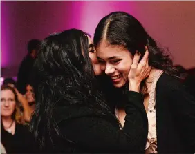  ?? DANA JENSEN/THE DAY ?? Scholarshi­p recipient Emma DeLaRosa, right, of Stonington High School, gets a kiss from her mother, Mariella, after receiving her award Thursday.