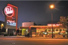  ??  ?? The casual Safari Inn and its neon surfboard sign in Burbank have been featured in movies and TV shows such as “Apollo 13” and “CSI Miami.”
There's carhop service a la the 1950s every Friday and Saturday night from 5 to 10 p.m. at Bob’s Big Boy in...
