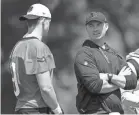  ?? ALBERT CESARE/THE ENQUIRER ?? Bengals coach Zac Taylor, here speaking to quarterbac­k Joe Burrow during a spring workout, canceled the team’s three-day minicamp.