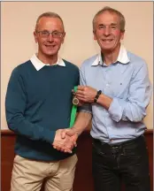  ??  ?? Michael Knight receives a Leinster over-60s bronze from Terry Kavanagh.