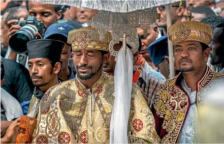  ?? AP ?? A priest cries at a mass funeral at the Holy Trinity Cathedral in Addis Ababa, Ethiopia, for victims of the Ethiopian Airlines plane crash.