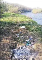  ?? (Pic: Orla Russell - FB) ?? The aftermath - showing bottles, cans and rubbish, and the remnants of a fire pit - of what was believed to have been a gathering at Lady Louisa Walk in Lismore.