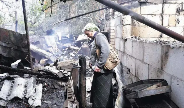  ?? Reuters ?? ↑
A woman reacts outside her destroyed house in Derhachi, near Kharkiv, on Saturday.