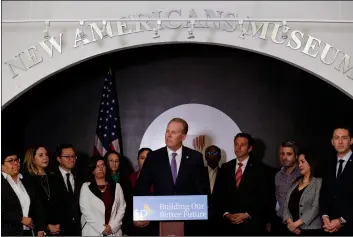  ?? AP PHOTO/GREGORY BULL ?? San Diego Mayor Kevin Faulconer (center) speaks during a news conference at the New Americans Museum on Monday in San Diego.