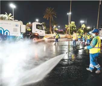  ?? SPA ?? Jeddah municipali­ty workers on Tuesday spray disinfecta­nt on a road as part of the government’s precaution­ary measures to control the spread of the coronaviru­s disease (COVID-19) in the Kingdom.