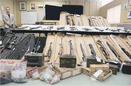  ?? PAUL CHIASSON / THE CANADIAN PRESS / FILE ?? Police in Longueuil, Que., display seized firearms. Criminals are using digital currency and creative shipping techniques to sell guns to Canadians.