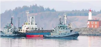  ??  ?? The MV Sun Sea is escorted past Fisgard Lighthouse and into CFB Esquimalt on Aug. 13, 2010.