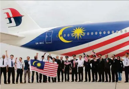  ??  ?? Malaysia Airlines officers and staff with the Airbus A350-900 (XWB) aircraft at the Kuala Lumpur Internatio­nal Airport in Sepang yesterday.