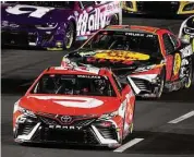  ?? Mark J. Terrill/Associated Press ?? NASCAR Cup Series driver Bubba Wallace, front, and Martin Truex Jr. race during the Busch Light Clash NASCAR exhibition auto race at Los Angeles Memorial Coliseum Sunday in Los Angeles.