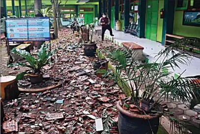  ?? HENDRA PERMANA / AP ?? Pieces of roof tiles and other debris litter the ground at a school following an earthquake in Malang, East Java, Indonesia, Saturday.