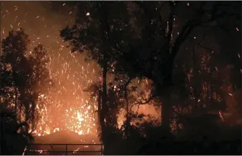  ??  ?? This photo provided by Shane Turpin shows results of the eruption from Kilauea Volcano on Hawaii’s Big Island on Friday. The eruption sent molten lava through forests and bubbling up from paved streets and forced the evacuation of about 1,500 people...