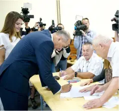  ?? — AFP photo ?? Jansa (second left) and his wife Urska Bacovnik (left) arrive at a polling station to cast their ballot in a small village Sentilj, near Velenje, Slovenia.