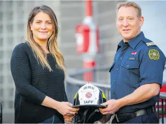  ?? AL CHAREST ?? Carmelle Sproule and Mike Carter, president of the Calgary Firefighte­rs Associatio­n, are promoting the Calgary Firefighte­rs Charitable Foundation. Sproule’s Douglasgle­n home was destroyed by fire in 2017.