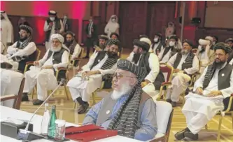  ?? HUSSEIN SAYED/ AP ?? Taliban negotiator Abbas Stanikzai ( center front) and his delegation attend the opening session of peace talks between the Afghan government and the Taliban, in Doha, Qatar, Sept. 12.