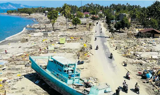  ??  ?? Zerstörte Häuser am Strand von Palu. Eine Tsunami-Warnung gab es, aber kaum jemand konnte sich rechtzeiti­g in Sicherheit bringen.