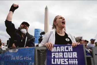  ?? Drew Angerer / Getty Images ?? Demonstrat­ors attend a March for Our Lives rally against gun violence in Washington on June 11. Congress passed new gun controls in response to a run of brutal mass shootings.