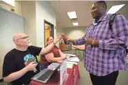  ?? COLIN BOYLE / MILWAUKEE JOURNAL SENTINEL ?? Oscar Jones of Milwaukee applies for a new library card with the Milwaukee Public Library at Home to Stay at Employ Milwaukee on Wednesday.