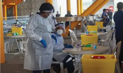  ?? Photograph: Kalolaine Fainu/The Guardian ?? Health workers administer Covid vaccines in Papua New Guinea in March. China has accused the Australian government of working to delay the authorisat­ion of the emergency use of Chinese vaccines in PNG.