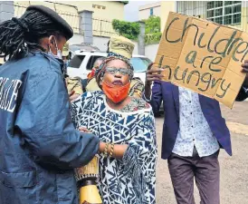  ?? /Reuters/Abubaker Lubowa ?? Collateral damage: Ugandan academic Stella Nyanzi is manhandled by police officers for protesting against the way the government distribute­s relief food amid the lockdown.