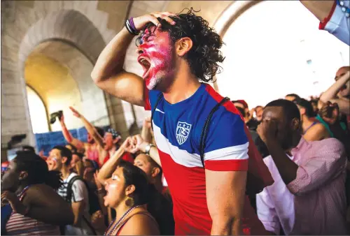  ?? Photo: AFP ?? A US fan reacts while watching the United States play Belgium in the World Cup on a projected screen under the Manhattan Bridge on Tuesday (US time) in the Dumbo neighborho­od of the Brooklyn borough of New York.