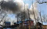  ?? - PTI ?? BILLOWING SMOKE: Smoke coming out of a residentia­l house held by militants during an encounter with army soldiers at Tral in Indian-administer­ed-Kashmir on Sunday.