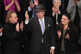  ?? WIN MCNAMEE — GETTY IMAGES ?? Paul Pelosi, husband of Rep. Nancy Pelosi, acknowledg­es the audience as Irish singersong­writer Bono and Ukrainian Ambassador to the U.S. Oksana Markarova applaud during President Joe Biden's State of the Union address.