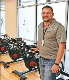  ?? STACI VANDAGRIFF/THREE RIVERS EDITION ?? Brandon Shrader, recreation superinten­dent for the Batesville Community Center and Aquatics Park, stands in the center’s fitness room. The Inaugural Indoor Triathlon is scheduled for Sept. 22 in the center, and the biking will be done on exercise bicycles. Registrati­on can be completed online at batesville­parks.com.To get a T-shirt, the registrati­on deadline is Tuesday.