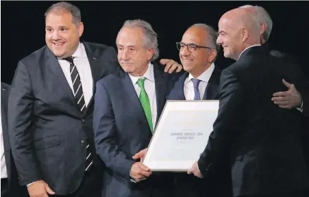  ?? ALEXANDER ZEMLIANICH­ENKO, THE ASSOCIATED PRESS ?? Canada’s Victor Montaglian­i, left, president of CONCACAF, celebrates with delegates from the U.S. and Mexico and FIFA President Gianni Infantino, right, after winning a joint bid to host the 2026 World Cup.