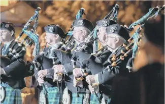  ??  ?? A pipe band performs at the Feast’s opening ceremony.