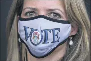  ?? PAUL SANCYA — THE ASSOCIATED PRESS ?? Michigan Secretary of State Jocelyn Bensonwear­s a mask before talking about voting and the upcoming elections in Detroit Thursday.