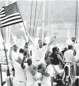  ?? BOB GALBRAITH/AP ?? America3 grinder Rick Brent raises the American flag in celebratio­n of their victory over Il Moro di Venezia to clinch the America’s Cup on May 16, 1992.