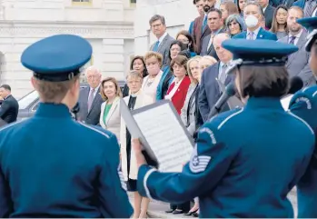  ?? J. SCOTT APPLEWHITE/AP ?? Members of the House stand on the steps of the U.S. Capitol on Thursday during a ceremony to honor the Americans who have died of COVID-19 as the number neared 1 million, a total reached Monday.