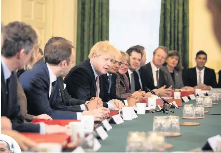  ??  ?? > Boris Johnson’s first Cabinet meeting after the General Election and, left, Walsall North MP Eddie Hughes