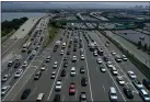  ?? JUSTIN SULLIVAN — GETTY IMAGES ?? Traffic backs up as vehicles approach the San Francisco-Oakland Bay Bridge toll plaza along Interstate 80on July 25in Oakland.