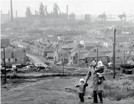  ??  ?? An out-of-work steel worker walking through Port Talbot, 1964