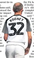  ??  ?? Early starter: A Derby fan wears the Rooney shirt before he even arrives